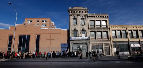 PHIL HOSSACK / WINNIPEG FREE PRESS - A line up of 'patrons' stretches way back from the door at the LightHouse Mission on Main street for a traditional Good Friday holiday meal. See release.  - April 19, 2019.