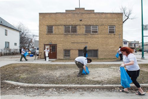 MIKE DEAL / WINNIPEG FREE PRESS
Andrew Allard (centre) and Tracey Cecchini (right) along with other members of the River City Bud Co clean up the area around Prichard Avenue and Salter Street Saturday afternoon during a BBQ for the community. 
190420 - Saturday, April 20, 2019.