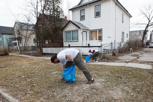 MIKE DEAL / WINNIPEG FREE PRESS
Andrew Allard (foreground) and Victoria Preston (background) along with other members of the River City Bud Co clean up the area around Prichard Avenue and Salter Street Saturday afternoon during a BBQ for the community. 
190420 - Saturday, April 20, 2019.