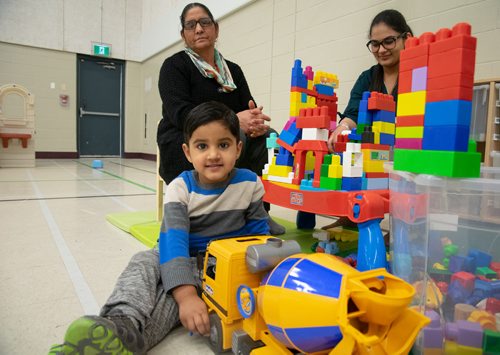 Canstar Community News Karman Toor plays with a truck at Weston Memorial Community Centre's Bright Start program while his grandmother Kuldeep Kaur and NorWest Community Co-op practicuum student Avneet Kaur look on. (EVA WASNEY/CANSTAR COMMUNITY NEWS/METRO)
