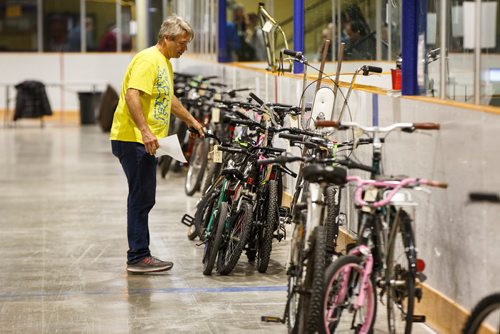 MIKE DEAL / WINNIPEG FREE PRESS
Volunteer Ron Caron looks for a bike that was won on auction during the two-day annual City of Winnipeg bike sale at the Terry Sawchuck Arena, 901 Kimberly Ave. 
190427 - Saturday, April 27, 2019.