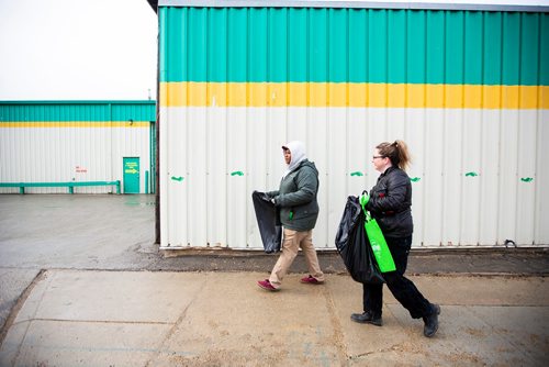 MIKAELA MACKENZIE/WINNIPEG FREE PRESS
Bola Opeseitan (left) and Janell Jones pick up garbage at Winnipeg BIZ's 14th annual Earth Day Cleanup in Winnipeg on Monday, April 29, 2019. 
Winnipeg Free Press 2019