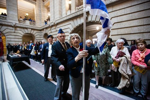 MIKAELA MACKENZIE/WINNIPEG FREE PRESS
Maureen Wiseman retires the flag of Israel with help from Dave Chochinov (left) at an annual public commemorative service held in remembrance of the Holocaust at the Manitoba Legislative Building in Winnipeg on Thursday, May 2, 2019. 
Winnipeg Free Press 2019