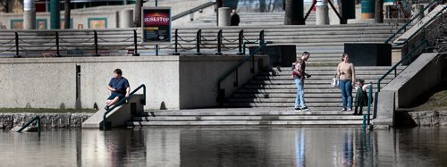 PHIL HOSSACK / WINNIPEG FREE PRESS  - Forks pedestrians bask in the sun as they made their way down to the Assiniboine River Walkway Friday to bask in the sun and check the receding water. STAND UP - May 3, 2019.