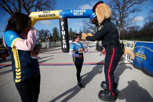 JOHN WOODS / WINNIPEG FREE PRESS
Copper, the mascot, hands out medals to kids who completed the Winnipeg Police Service Half Marathon at Assiniboine Park in Winnipeg Sunday, May 5, 2019.

Reporter: Alex