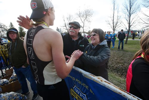 JOHN WOODS / WINNIPEG FREE PRESS
Nickolas Kosmenko who won the Winnipeg Police Service Half Marathon with a time of 1:12:15.7, is congratulated by his parents Noreen and Lyndon at Assiniboine Park in Winnipeg Sunday, May 5, 2019.

Reporter: Alex