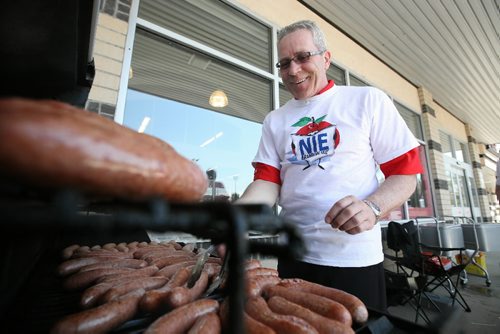 Brandon Sun 22052009 Brandon SUN Advertising Manager Glen Parker cooks up some hotdogs during the Newspapers In Education Barbeque at the Heritage Co-op on Richmond Ave. in Brandon on Friday. (Tim Smith/Brandon Sun)