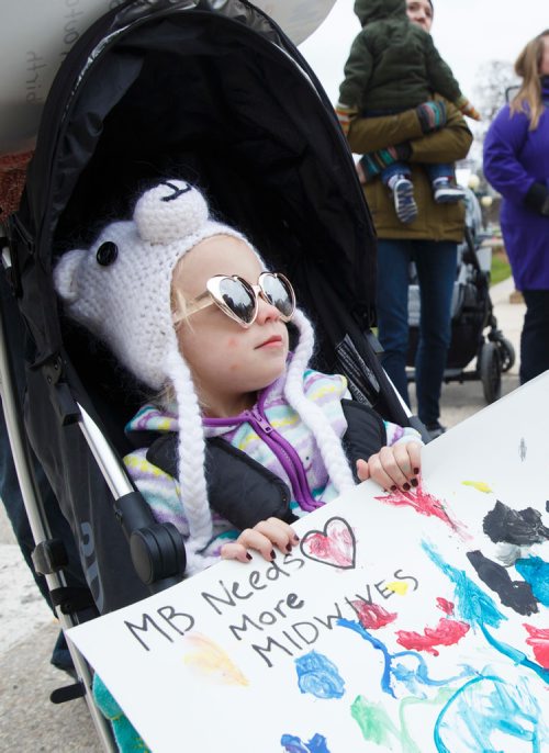 MIKE DEAL / WINNIPEG FREE PRESS
Poppy Haywood, 2, holds a sign stating that Manitoba needs more midwives during a rally on the steps of the Manitoba Legislative building Monday morning. Word is that there are so few jobs in Manitoba for midwives that graduates have to leave the province to get work
See Carol Sanders story. 
190506 - Monday, May 06, 2019.