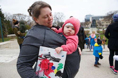 MIKE DEAL / WINNIPEG FREE PRESS
Ashley Ford and her nine-month-old, Daisy,  during a rally on the steps of the Manitoba Legislative building Monday morning. Word is that there are so few jobs in Manitoba for midwives that graduates have to leave the province to get work
See Carol Sanders story. 
190506 - Monday, May 06, 2019.