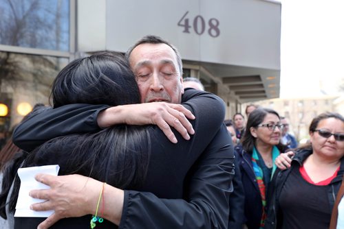 RUTH BONNEVILLE / WINNIPEG FREE PRESS 

George and his wife Melinda Wood, parents of murder victim Christine Wood, are embraced by family and community members outside the Law Courts building after George makes a statement to the media regarding the sentencing of  Brett Overby who was convicted of 2nd degree murder on Wednesday.

May 8, 2019

