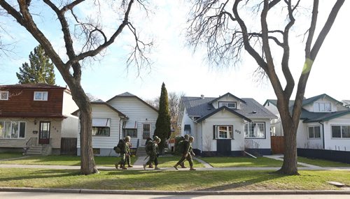 MIKE DEAL / WINNIPEG FREE PRESS
Members of 38 Combat Engineer Regiment conduct a ruck march along Machray Ave in the area of LCol Harcus Strachan VC MC Armoury in Winnipeg Friday morning. 
190510 - Friday, May 10, 2019
