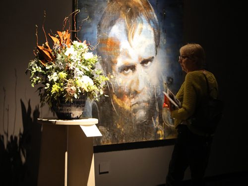 JASON HALSTEAD / WINNIPEG FREE PRESS

Ann Rallison checks out Debra Moore's floral interpretation of artist Tony Scherman's painting Brando as Napoleon at the Art in Bloom Preview Party at the Winnipeg Art Gallery on April 11, 2019. (See Social Page)