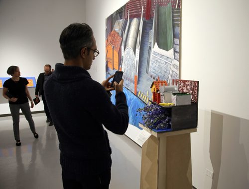 JASON HALSTEAD / WINNIPEG FREE PRESS

Adam Moz snaps a photo of Art City's floral interpretation of artist Eleanor Bond's Departure of the Industrial Workers at the Art in Bloom Preview Party at the Winnipeg Art Gallery on April 11, 2019. (See Social Page)
