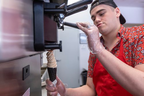 SASHA SEFTER / WINNIPEG FREE PRESS
Assistant Store Manager Alex Berens serves up an orange creamsicle inspired soft serve ice cream on top of a black charcoal cone at Teeyah's Candy, Soda and Ice Cream in downtown Winnipeg. See Alison Gillmor review.
190510 - Friday, May 10, 2019.