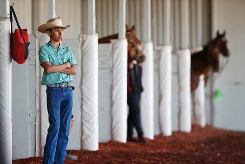 JOHN WOODS / WINNIPEG FREE PRESS
Juan Pablo Silva Jr., assistant trainer for his father, waits for their horse Kaufy Buzz to return to its paddock stall on opening day at Assiniboia Downs in Winnipeg Sunday, May 12, 2019.

Reporter: Sports Feature