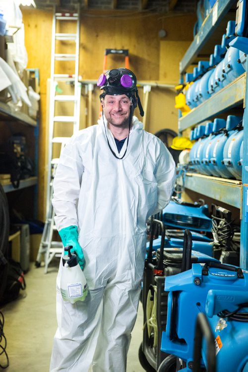 MIKAELA MACKENZIE / WINNIPEG FREE PRESS
Scott Rose, owner and general manager of WinMar property restoration, poses for a portrait in cleanup gear with stored air moving machines and dehumidifiers at their facility in Winnipeg on Monday, May 13, 2019.  For Erin Lebar story.
Winnipeg Free Press 2019.