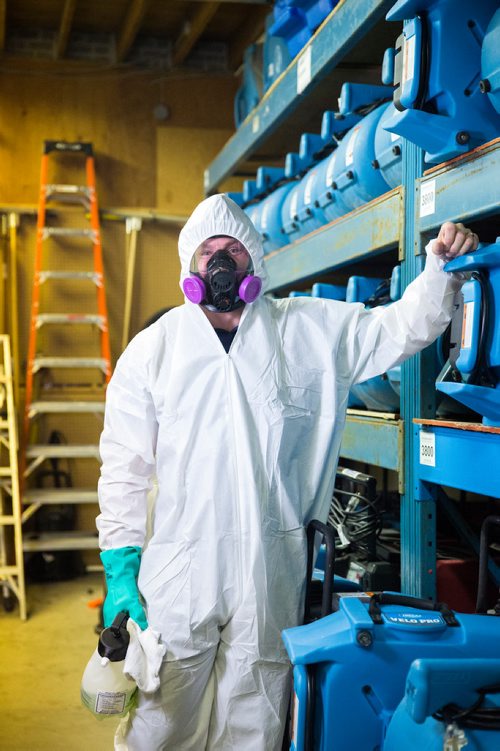 MIKAELA MACKENZIE / WINNIPEG FREE PRESS
Scott Rose, owner and general manager of WinMar property restoration, poses for a portrait in cleanup gear with stored air moving machines and dehumidifiers at their facility in Winnipeg on Monday, May 13, 2019.  For Erin Lebar story.
Winnipeg Free Press 2019.