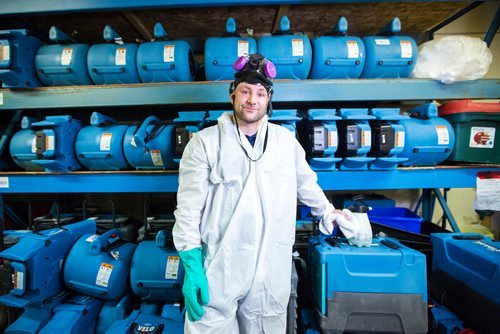 MIKAELA MACKENZIE / WINNIPEG FREE PRESS
Scott Rose, owner and general manager of WinMar property restoration, poses for a portrait in cleanup gear with stored air moving machines and dehumidifiers at their facility in Winnipeg on Monday, May 13, 2019.  For Erin Lebar story.
Winnipeg Free Press 2019.