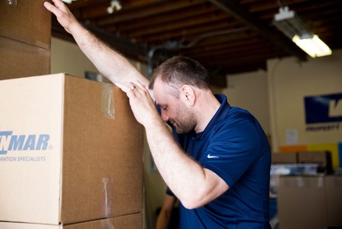 MIKAELA MACKENZIE / WINNIPEG FREE PRESS
Scott Rose, owner and general manager of WinMar property restoration, balances boxes while moving them at their facility in Winnipeg on Monday, May 13, 2019.  For Erin Lebar story.
Winnipeg Free Press 2019.