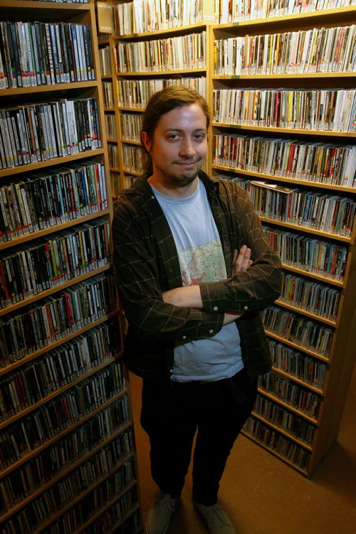 PHIL HOSSACK / WINNIPEG FREE PRESS - U of W's CKUW radio station is celebrating 20 years on FM radio: current program director, Sam Doucet poses in their music library. See story.  - May14, 2019, 2019.
