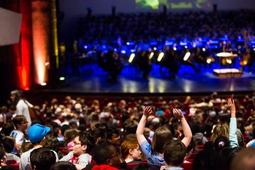 MIKAELA MACKENZIE / WINNIPEG FREE PRESS
Kids in the audience wave to the over 200 students that will sing with the Winnipeg Symphony Orchestra as part of the Adventures in Music program before the show starts at the Centennial Concert Hall in Winnipeg on Tuesday, May 14, 2019. 
Winnipeg Free Press 2019.