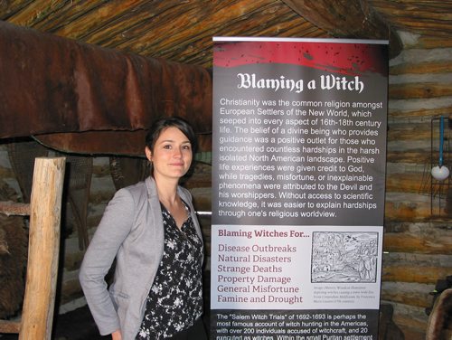 Canstar Community News May  7, 2019 - Fort la Reine executive director Madison Connelly is shown in the musuem's Trapper's Cabin with one of the panels that are part of the musuem's Witchcraft Explored exhibition on until Nov. 15. (ANDREA GEARY/CANSTAR COMMUNITY NEWS)