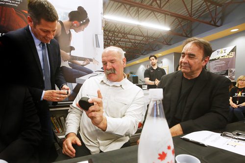 JOHN WOODS / WINNIPEG FREE PRESS
Former Winnipeg Jet and Hockey Helps the Homeless (HHTH) Ambassadors, Dave Babych, centre, and his brother Wayne are presented with commemorative pucks by mayor Brian Bowman during a HHTH press conference at Resource Assistance for Youth (RAY) in Winnipeg Tuesday, May 14, 2019. HHTH announced their Winnipeg tournament to assist local homeless service agencies. HHTH is a Canadian not-for-profit that hosts fantasy hockey tournaments, where amateur hockey players get to lace up with some of Canadas most admired NHL Alumni and Olympic Gold Medalists to raise awareness and funds that make a direct impact in their community. 
Reporter: Bell