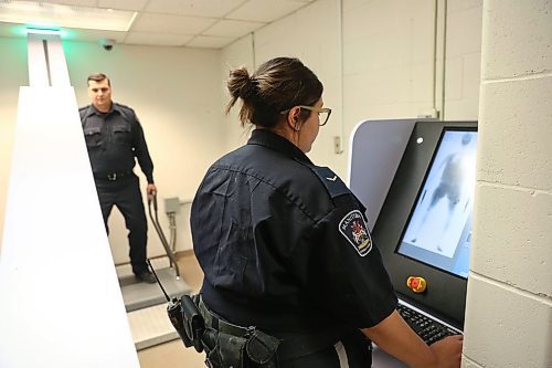 MIKE DEAL / WINNIPEG FREE PRESS
Correctional Officers Melissa and Clayton demonstrate the new body scanner in the Winnipeg Remand Centre during an announcement by Justice Minister Cliff Cullen Thursday morning. New scanners have been installed in correctional centres in Winnipeg, Brandon, and The Pas in an effort to keep drugs and other contraband out of Manitoba jails. 
190516 - Thursday, May 16, 2019
190516
Thursday, May 16, 2019