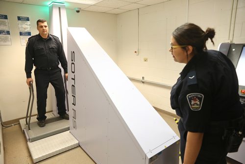 MIKE DEAL / WINNIPEG FREE PRESS
Correctional Officers Melissa and Clayton demonstrate the new body scanner in the Winnipeg Remand Centre during an announcement by Justice Minister Cliff Cullen Thursday morning. New scanners have been installed in correctional centres in Winnipeg, Brandon, and The Pas in an effort to keep drugs and other contraband out of Manitoba jails. 
190516 - Thursday, May 16, 2019
190516
Thursday, May 16, 2019