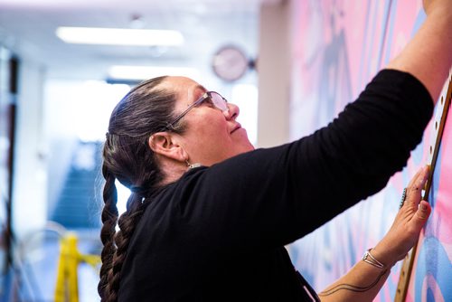 MIKAELA MACKENZIE / WINNIPEG FREE PRESS
Michif artist Christi Belcourt creates a mural titled Thunderbird Uprising in a hallway in the Isbister Building of the Faculty of Arts at the University of Manitoba in Winnipeg on Thursday, May 16, 2019. 
Winnipeg Free Press 2019.