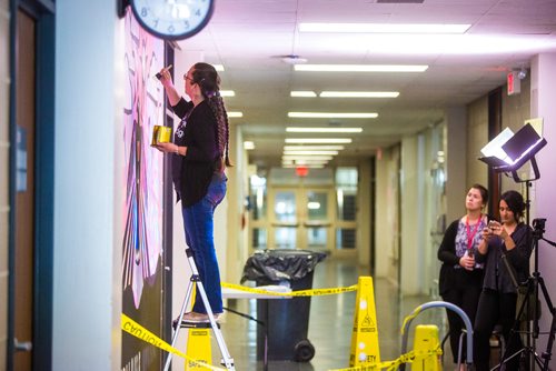 MIKAELA MACKENZIE / WINNIPEG FREE PRESS
Michif artist Christi Belcourt creates a mural titled Thunderbird Uprising as Office of Indigenous Engagement project assistant Sarah Olson (left) and communications coordinator Nickita Longman watch in a hallway in the Isbister Building of the Faculty of Arts at the University of Manitoba in Winnipeg on Thursday, May 16, 2019. 
Winnipeg Free Press 2019.