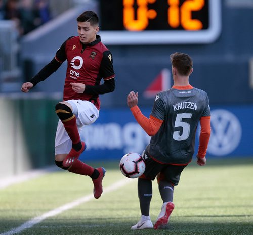 PHIL HOSSACK / WINNIPEG FREE PRESS -Valour FC #8 Diego Gutierrez kicks a pass backwards away from ForgeFC #5 Daniel Krutzen in action Thursday at Investors Group Field. See story. - May 16, 2019