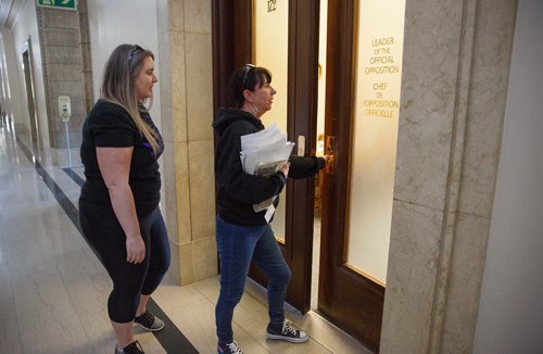 MIKE DEAL / WINNIPEG FREE PRESS
Carrying an armful of documents she is handing over to the NDP the Official Opposition, Arlene Last-Kolb (right) has been working with Rebecca Rummery (left) cofounder of Overdose Manitoba to petition the provincial government to take action on the addictions crises.
190517 - Friday, May 17, 2019.