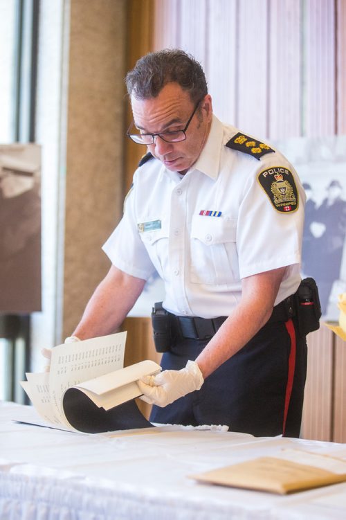 MIKAELA MACKENZIE / WINNIPEG FREE PRESS
Winnipeg Police Service Chief Danny Smyth opens the contents of a time capsule placed within the Public Safety Building on November 30, 1965 at city hall in Winnipeg on Tuesday, May 21, 2019. For Aldo Santin story.
Winnipeg Free Press 2019.