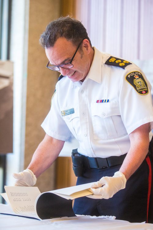 MIKAELA MACKENZIE / WINNIPEG FREE PRESS
Winnipeg Police Service Chief Danny Smyth opens the contents of a time capsule placed within the Public Safety Building on November 30, 1965 at city hall in Winnipeg on Tuesday, May 21, 2019. For Aldo Santin story.
Winnipeg Free Press 2019.