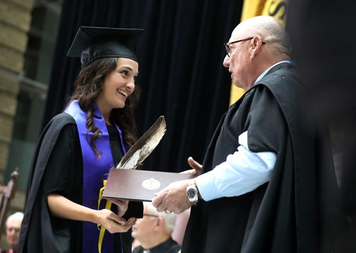 RUTH BONNEVILLE / WINNIPEG FREE PRESS 

LOCAL - U of M 140th Convocation

Amanda Fontes holds an eagle feather as she shakes the hand of The University of Manitoba Chancellor Harvey Secter after receiving her doctor of medicine degree at the 140th annual convocation of the Rady Faculty of Health Sciences in the Brodie Centre Atrium, University of Manitoba Bannatyne Campus on Thursday.  

She is one of 11 students who  self-declared Indigenous ancestry in her class of 109 graduates.  

Amanda Fontes also received the Manitoba Medical College Foundation Award (MMCF - Paul Nehra Convocation Prize in Family Medicine) which is awarded to a student who has demonstrated excellence in their performance during the Family Medicine/Public Health Clerkship rotation, and who has been accepted to post-graduate studies in Family Medicine for the next academic session.  




May 23, 2019
