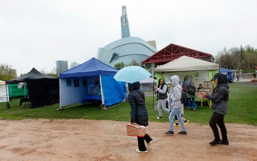 PHIL HOSSACK / WINNIPEG FREE PRESS - What patrons braved the windy drizzle Friday evening stayed under umbrellas as the annual Night Market opened at the Forks. Warmer Sunnier weather is on the way for the weekend.  - May24, 2019.