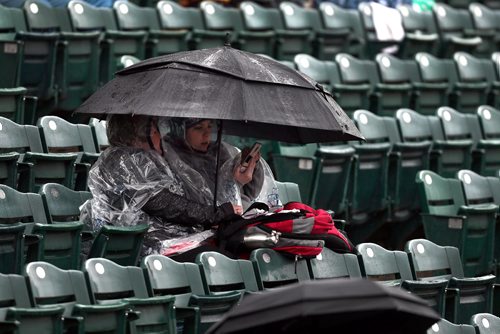 PHIL HOSSACK / WINNIPEG FREE PRESS - Loyal Goldeye fans came prepared in rain gear and umbrellas to wait for a home opener that was rained out Friday night at Shaw Park, they also brought smart phones, maybe to check the forecast for the rest of the weekend. Tomorrow is warmer and sunny.  - May24, 2019.
