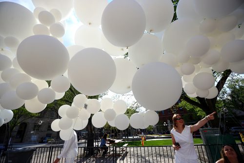 TREVOR HAGAN / WINNIPEG FREE PRESS
Laurena Ens checks out the balloons at the Genuwine Cellars table at Table for 1200 More along Albert Street, Saturday, May 25, 2019.