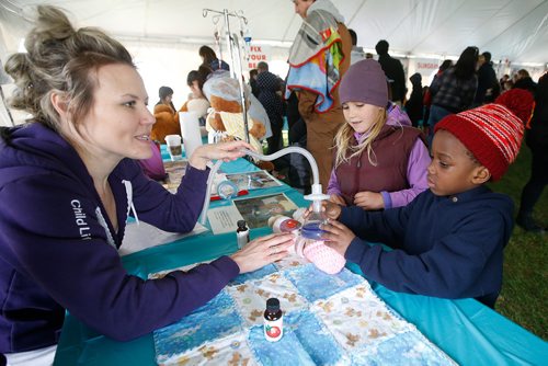 JOHN WOODS / WINNIPEG FREE PRESS
Stephanie Bradford, Child Life Specialist, helps Vaniya, 8, and Maayiri, 4,prepare their toy for surgery at the Teddy Bear Picnic in Assiniboine Park, Winnipeg Sunday, May 26, 2019.

Reporter: ?