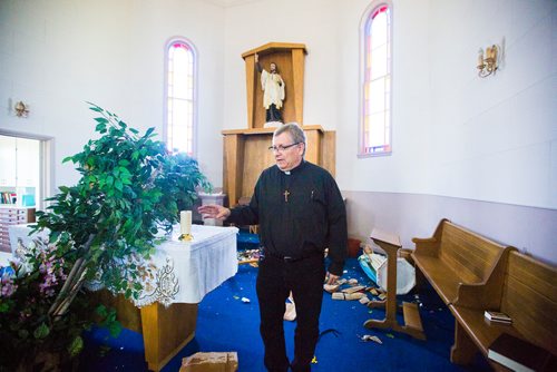 MIKAELA MACKENZIE / WINNIPEG FREE 
Fr. Michel Nault walks through the vandalized St. Francois Xavier Catholic Church in the small town west of Winnipeg on Monday, May 27, 2019.  For Bill Redekop story.
Winnipeg Free Press 2019.