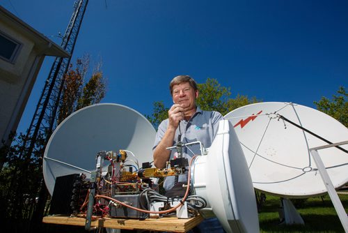 MIKE DEAL / WINNIPEG FREE PRESS
Barry Malowanchuk in his "ham shack" has been a ham radio operator for close to 60 years.
In his backyard that has two large dishes and a fifty foot radio antenna tower. 
Barry with his 78 GHz Portable Microwave Radio on a tripod. It is a very high performance radio at the highest frequency range to be used to support the new 5G cell systems (when they arrive) and is starting to be used to transport very high speed Internet (10 Gigabits/sec).190527 - Monday, May 27, 2019.