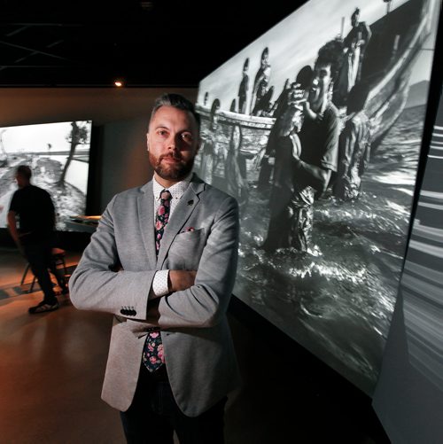 PHIL HOSSACK / WINNIPEG FREE PRESS - CMHR Manager of Design & Production Rob Vincent poses in front of photographs by Kevin Frayer of Rohingya's refugees, part of an Exhibition at the Human Rights Museum opening next month. - May 28, 2019.