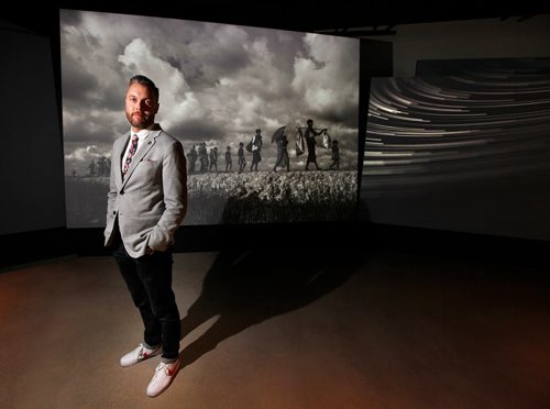 PHIL HOSSACK / WINNIPEG FREE PRESS - CMHR Manager of Design & Production Rob Vincent poses in front of photographs by Kevin Frayer of Rohingya's refugees, part of an Exhibition at the Human Rights Museum opening next month. - May 28, 2019.