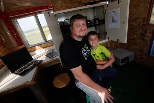 PHIL HOSSACK / WINNIPEG FREE PRESS - Ham Radio enthusiast Bill Fleury and his son Billy (7) right, pose in their East Kildonan "Ham Shack". See Dave Sanderson's story. - May 28, 2019.