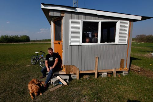 PHIL HOSSACK / WINNIPEG FREE PRESS - Ham Radio enthusiast Bill Fleury sits on the step of his Ham Shack and his sons Avi (12) and Billy (7) left, peer out if the window. See Dave Sanderson's story. - May 28, 2019.