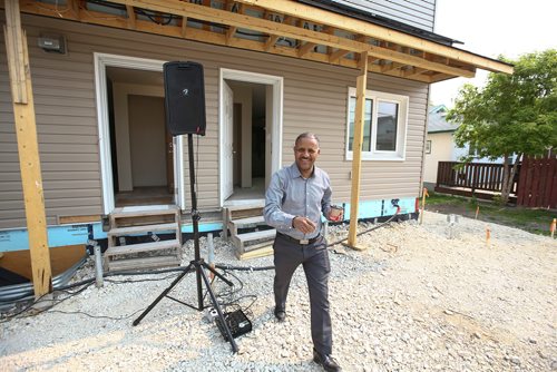 MIKE DEAL / WINNIPEG FREE PRESS
New homeowner, Kahasse, smiles after getting a chance to look inside his almost completed home.
Habitat for Humanity unveiled the almost completed first ever Net Zero construction project, on Logan Avenue Thursday morning.
The four-plex at 1860 Logan Avenue is the first Habitat Net Zero home as well as the first of its kind build project by any builder in Manitoba. These homes should produce as much energy as the homeowner uses.
190530 - Thursday, May 30, 2019.