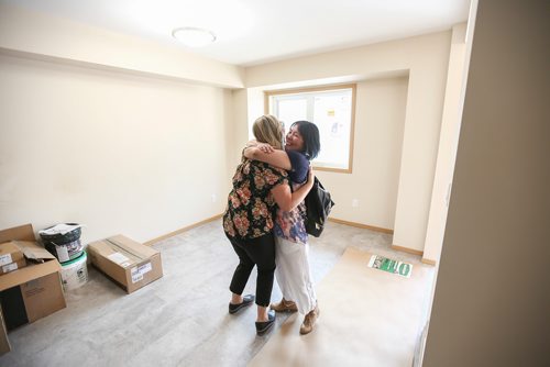 MIKE DEAL / WINNIPEG FREE PRESS 
Merlyn excitedly hugs and thanks Kelly Kluger, Manager of Volunteer Services Habitat for Humanity, while getting a first time look inside her new home that she will move into with her two sons.
Habitat for Humanity unveiled the almost completed first ever Net Zero construction project, on Logan Avenue Thursday morning.
The four-plex at 1860 Logan Avenue is the first Habitat Net Zero home as well as the first of its kind build project by any builder in Manitoba. These homes should produce as much energy as the homeowner uses.
190530 - Thursday, May 30, 2019.