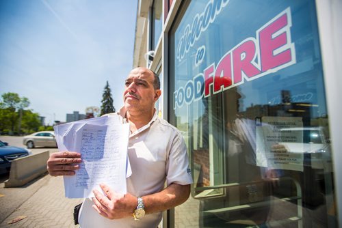 MIKAELA MACKENZIE / WINNIPEG FREE PRESS
Food Fare owner Munther Zeid poses for a portrait with his petition to change the provincial act on store opening hours at Food Fare in Winnipeg on Friday, May 31, 2019.   
Winnipeg Free Press 2019.