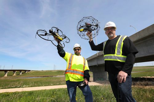 RUTH BONNEVILLE /  WINNIPEG FREE PRESS 

BIZ - drone regs

Photo of Rob Walker (black shirt), managing director with Canaddrone and Walter Weselowski chief drone pilot, as they hold specialized drones that they use for commercial drone services like inspecting under bridges and survey work.  Photo taken near Dugald Rd. bridge over Floodway where have done inspection work.  
 

Story is about how  Transport Canada is instituting new regulation on operation of drones starting tomorrow which separates the licensed drone operators from other non-licensed drone pilots.  

See Martin Cash  | Business Reporter/ Columnist story. 

May 31, 2019
